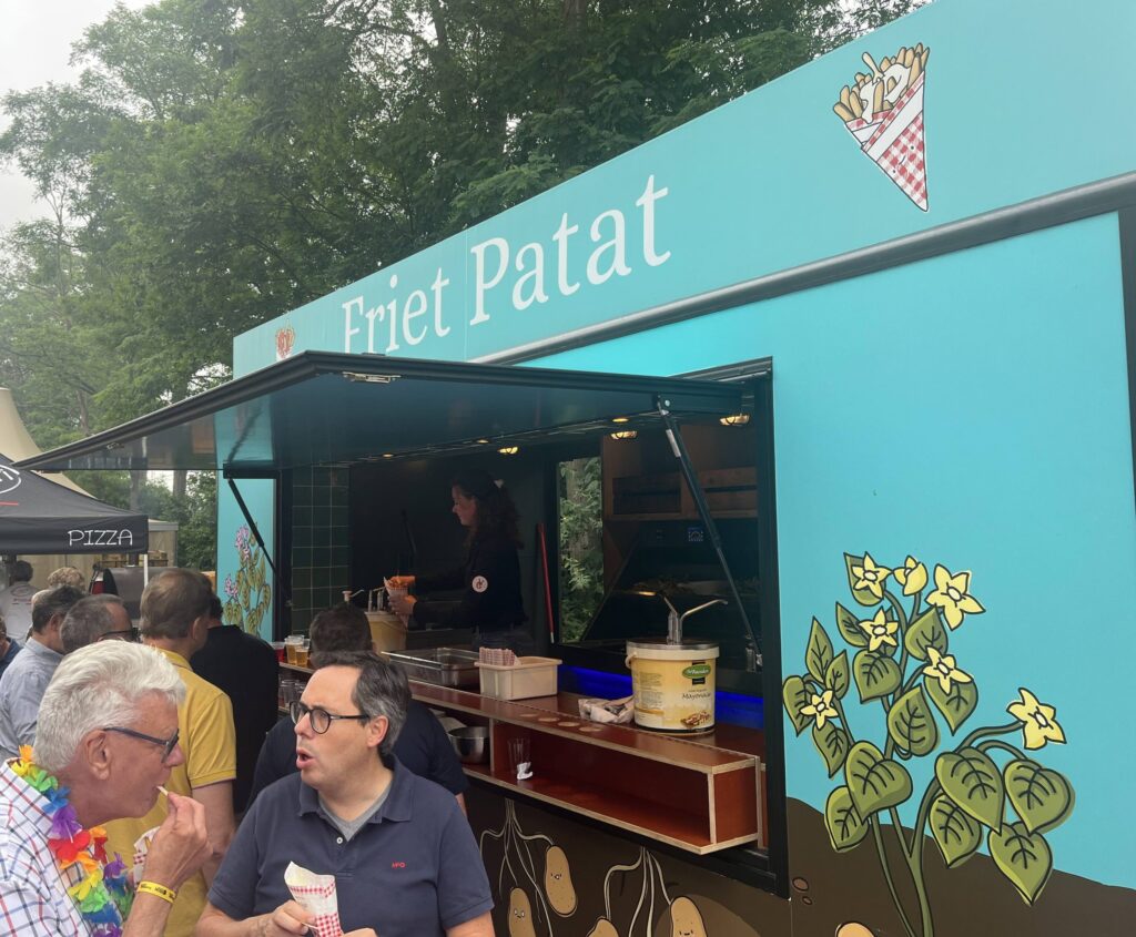 a group of people standing outside a food truck